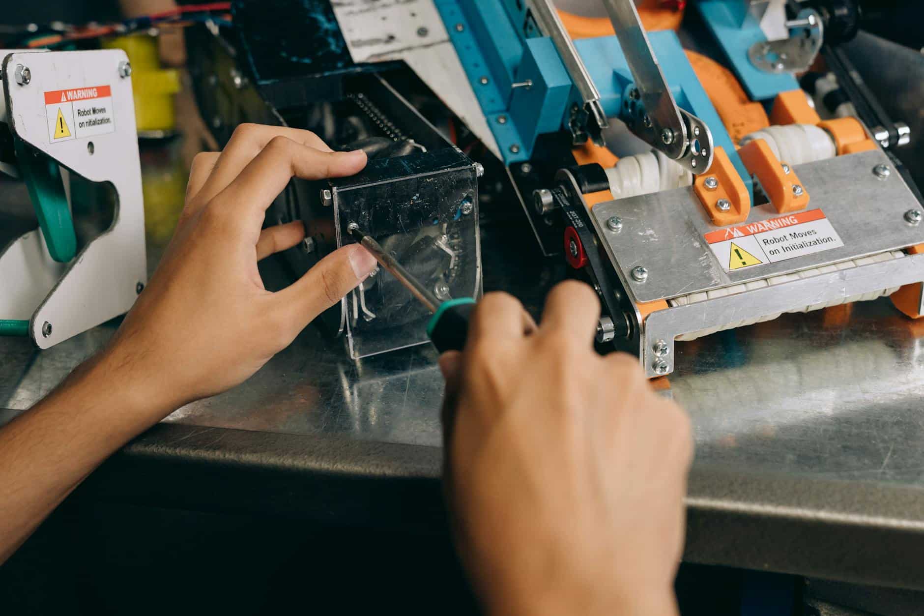 Technician performing preventive maintenance on robotic equipment