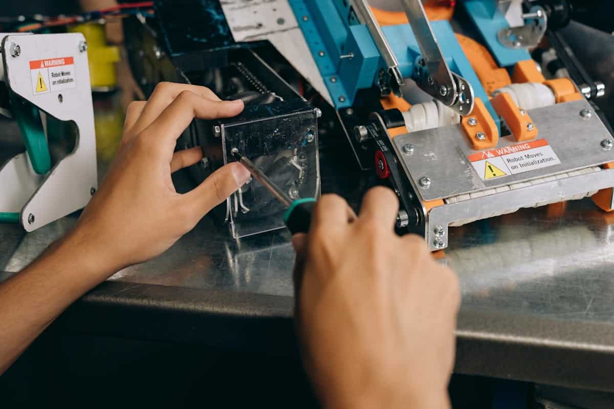 Technician performing preventive maintenance on an industrial robot