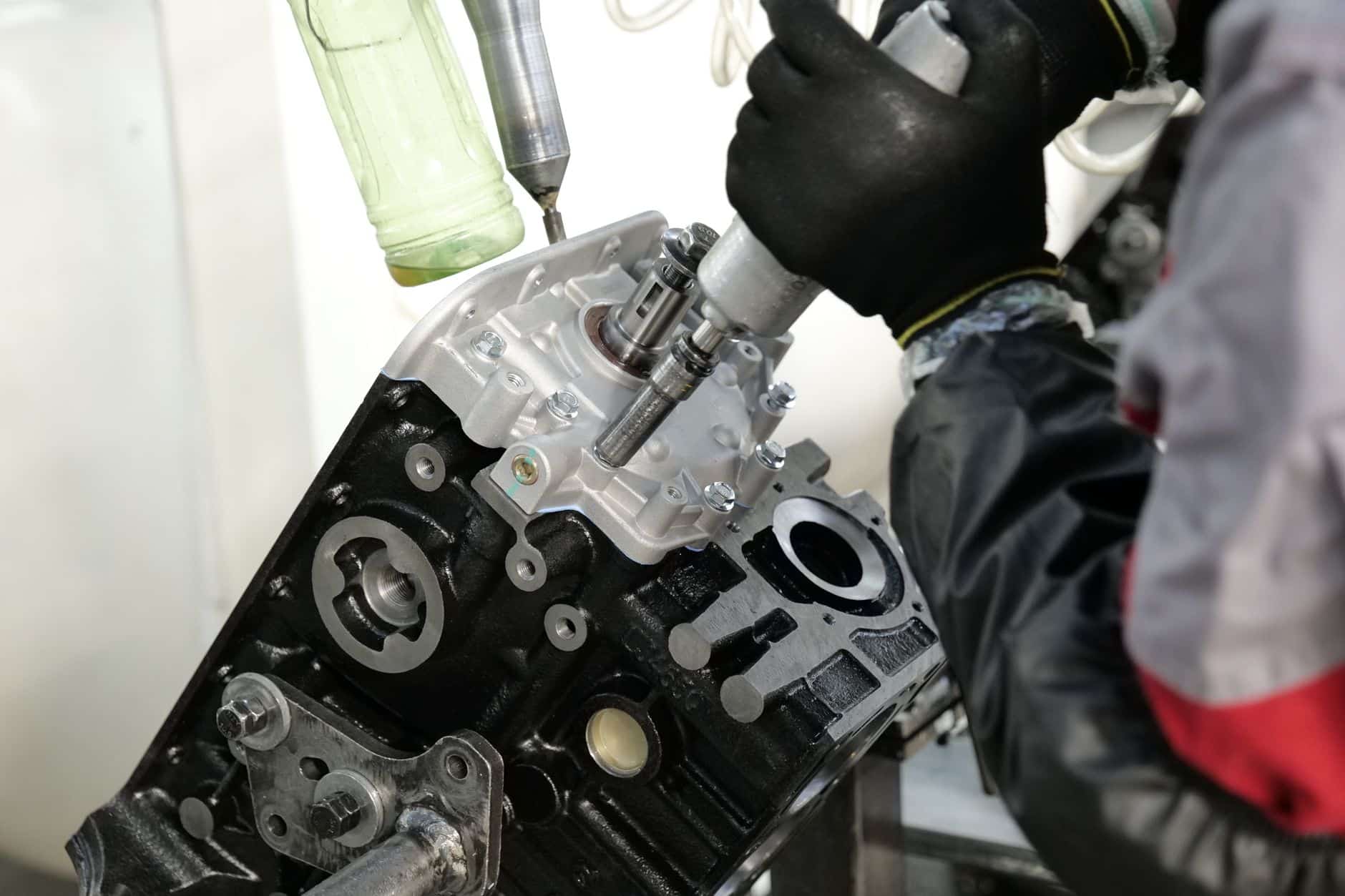 Technician inspecting a robot cable bundle during a maintenance round