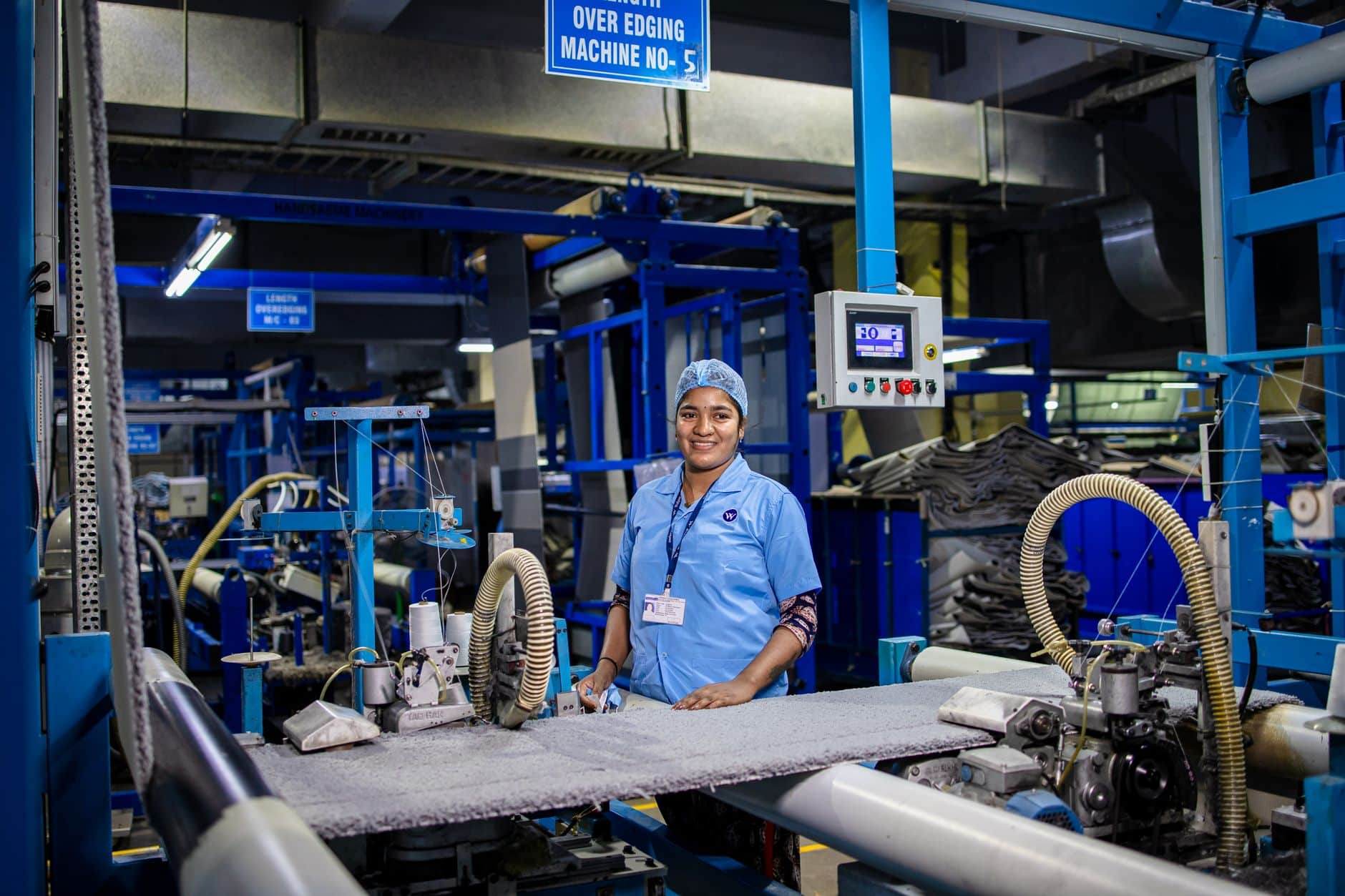 Engineer measuring an installed robot before a custom cover is cut