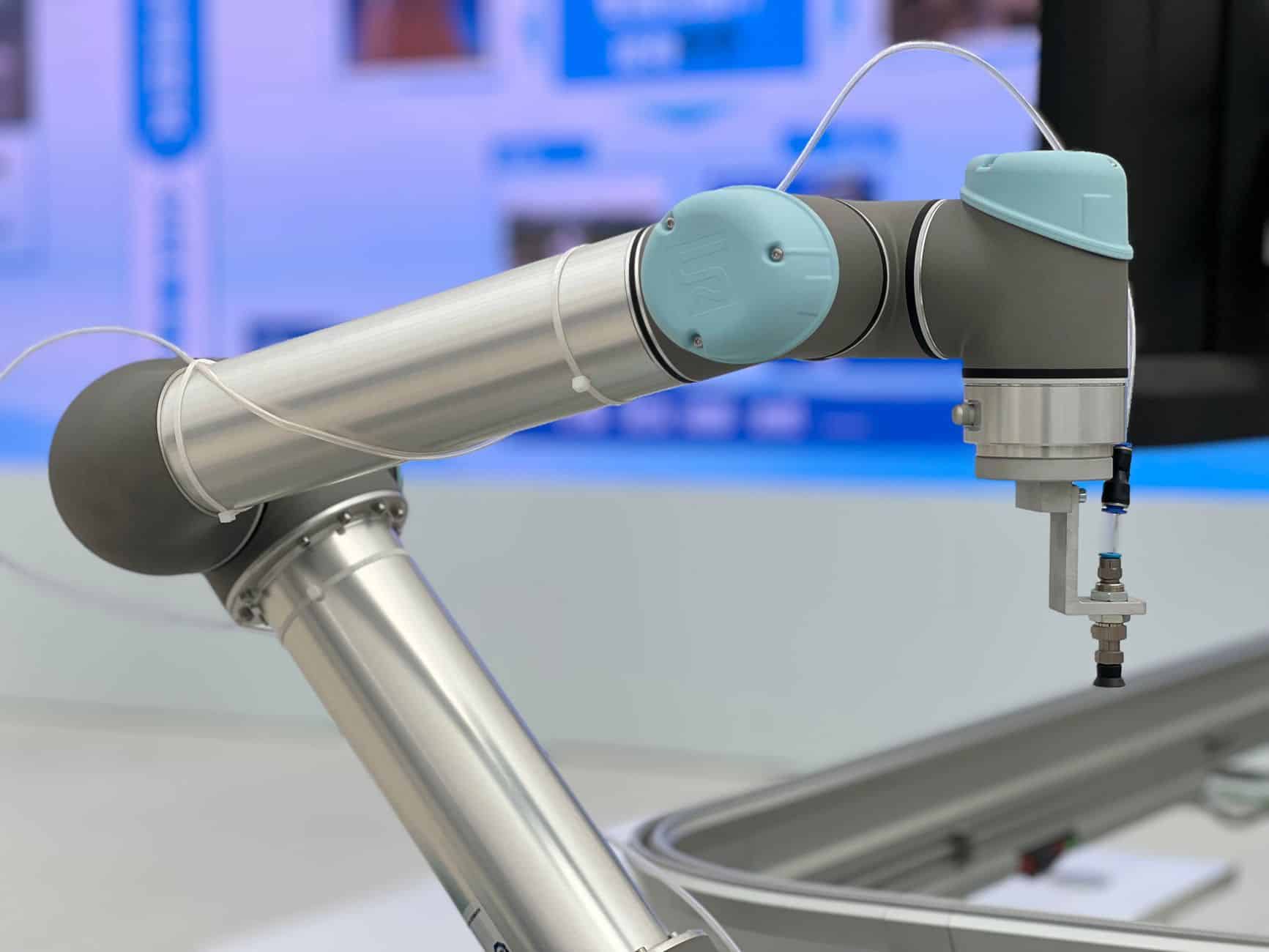 Close-up of an industrial robotic arm mechanism showing cable routing and flex points
