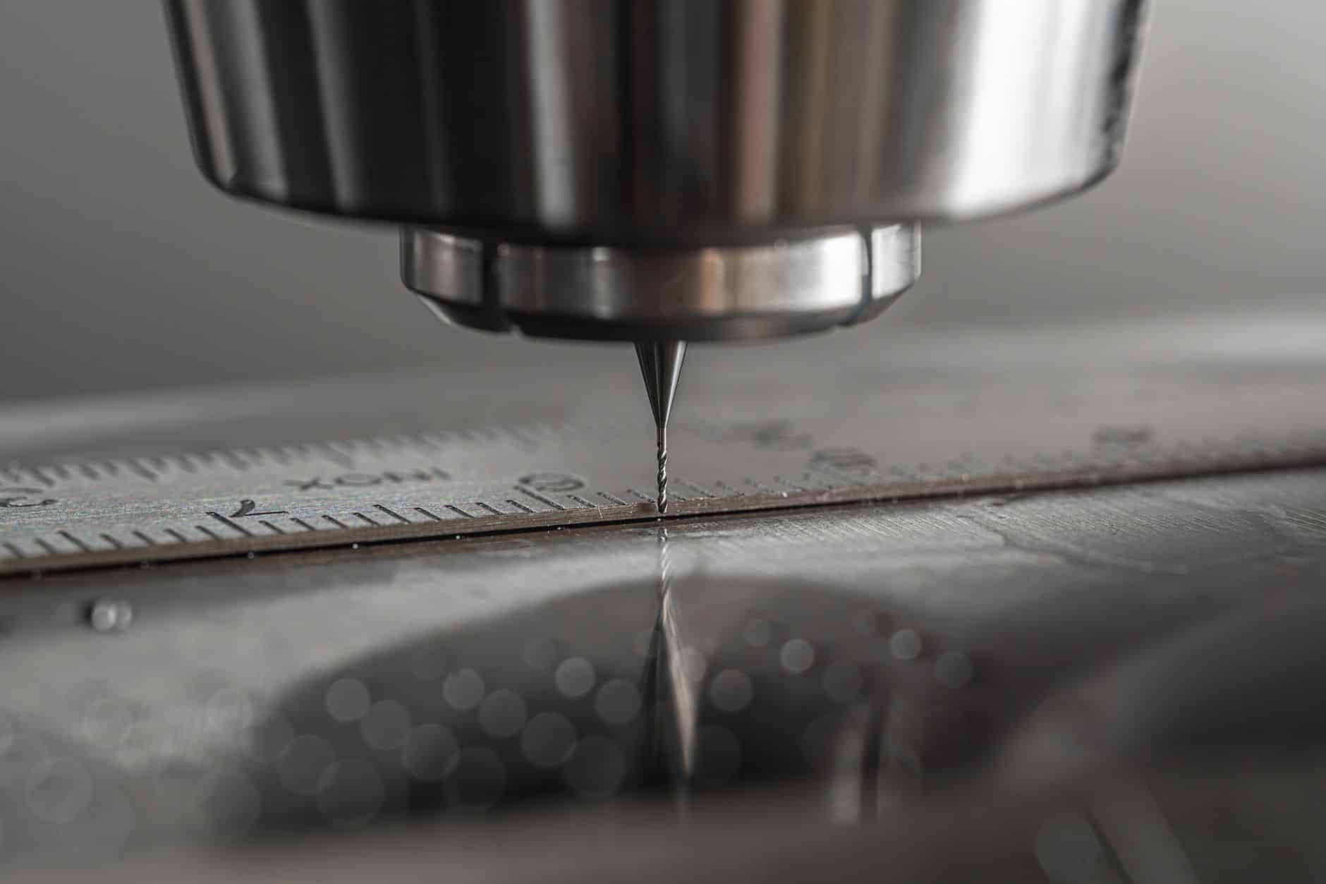 Metal chips and swarf accumulating around a CNC machine on the shop floor