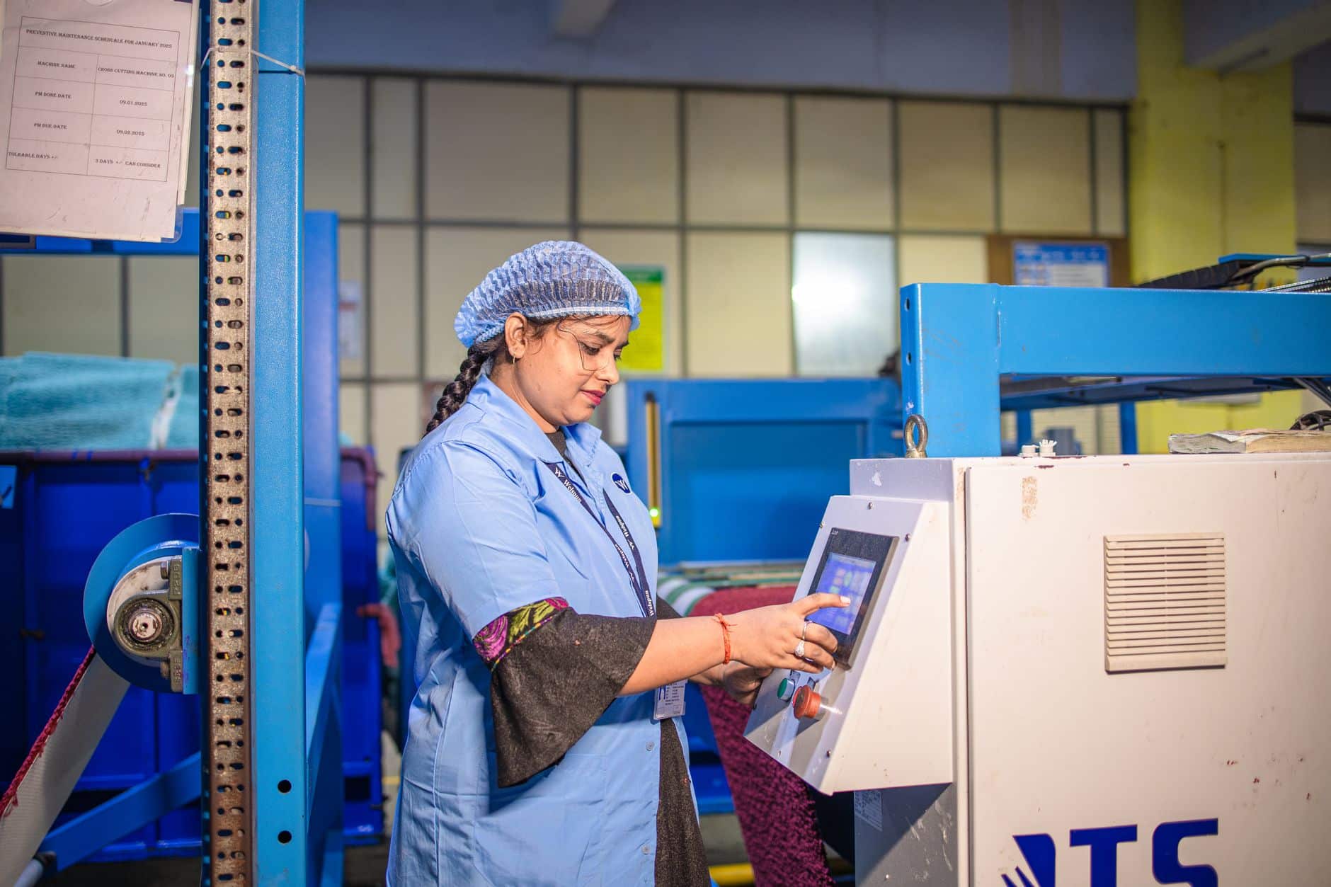 Engineer measuring an industrial machine before ordering a custom equipment cover