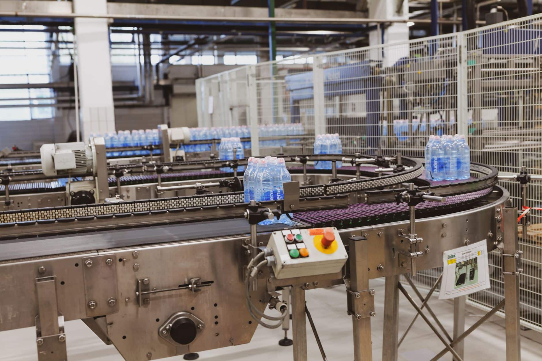 Packaging line conveyor with access points along its length